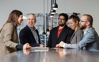 Mehrere Personen stehen um einen Tisch