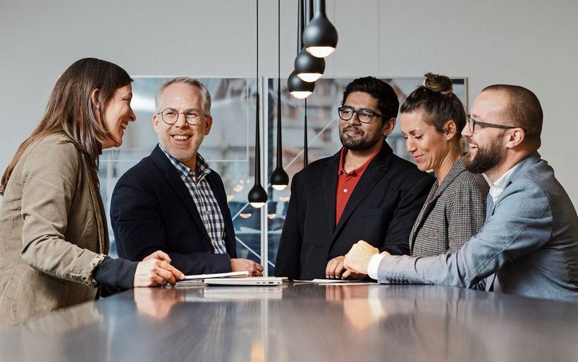 Mehrere Personen stehen um einen Tisch